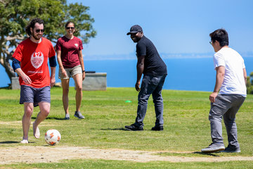 Students playing soccer in Alumni Park